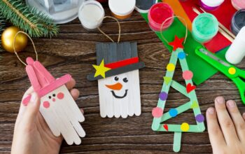 A child is holding Christmas decoration or Christmas gift wooden sticks. Handmade. Project of children's creativity, handicrafts, crafts for kids.